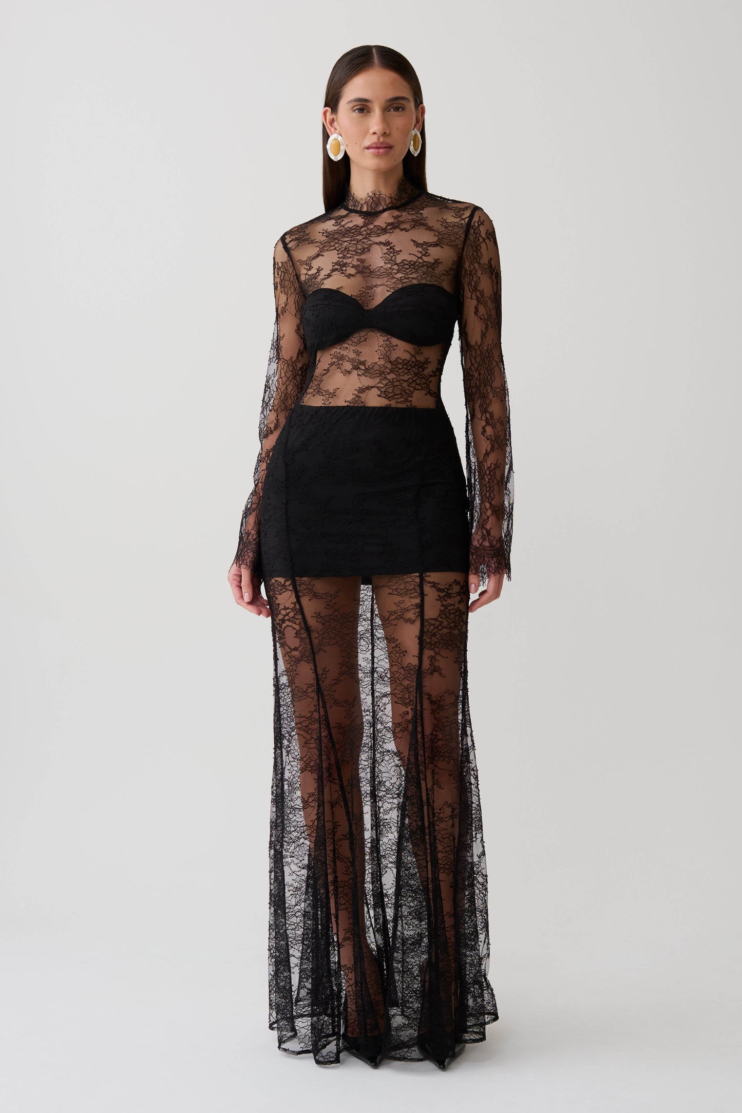Woman wearing a black long sleeve lace maxi dress.