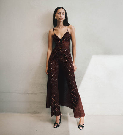 Woman wearing a brown set with embellishments.