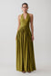 Woman wearing a olive green halter maxi dress.