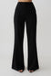 Woman wearing black high waisted suiting pants.