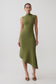 Woman wearing a green pleated knit dress.
