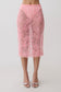Woman wearing a pink lace midi skirt.