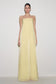Woman wearing light yellow strapless maxi dress.