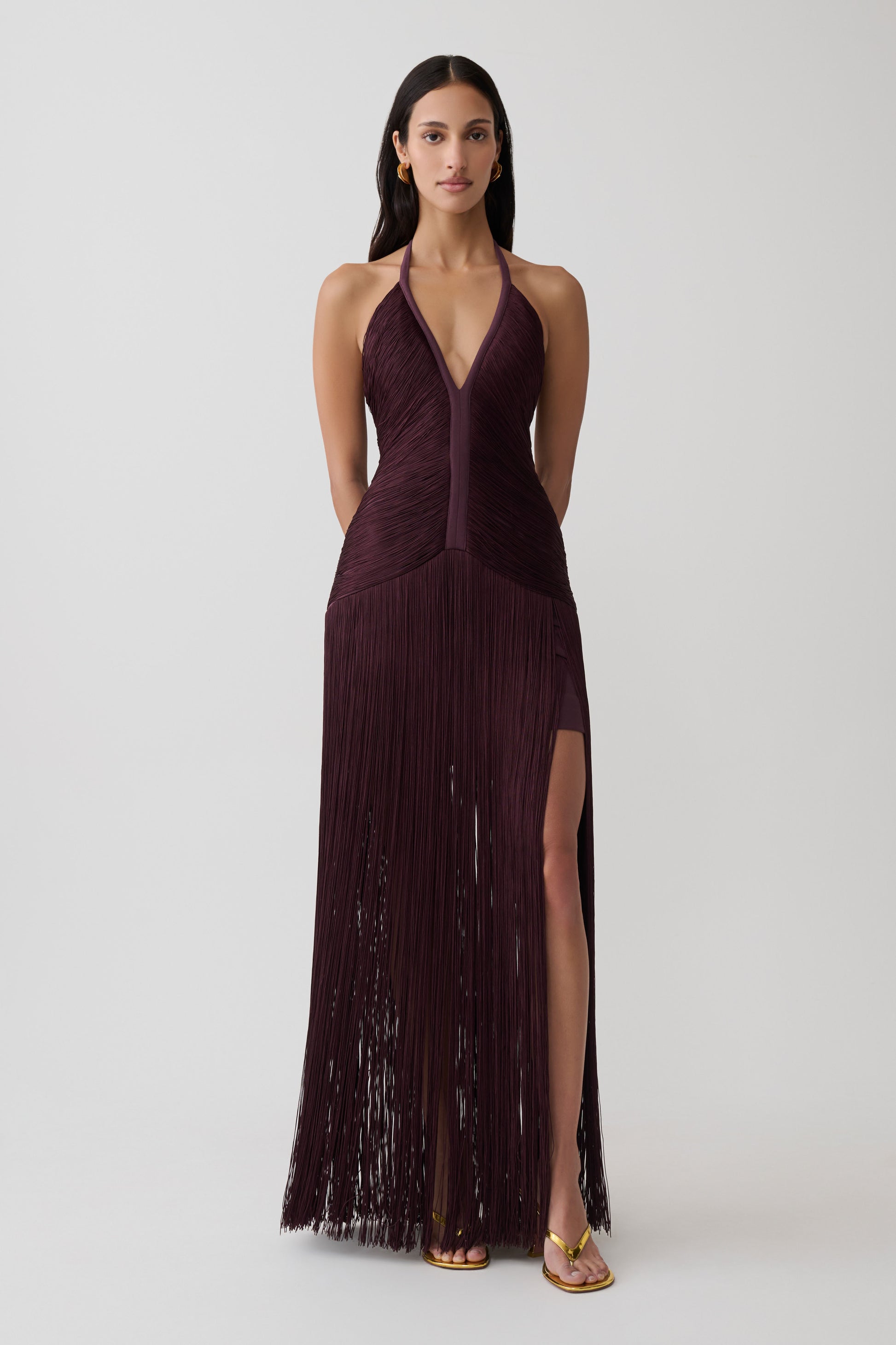 Woman wearing a purple fringe maxi dress.