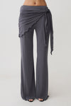Woman wearing straight leg pants with waist wrap.