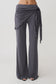 Woman wearing straight leg pants with waist wrap.