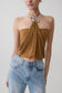 Woman wearing a caramel halter top with hardware.