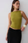 Woman wearing green backless twist top.