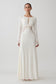 Woman wearing a white lace slinky maxi dress.