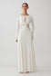 Woman wearing a white lace slinky maxi dress.