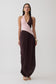Woman wearing a pink and brown halter gathered maxi dress.