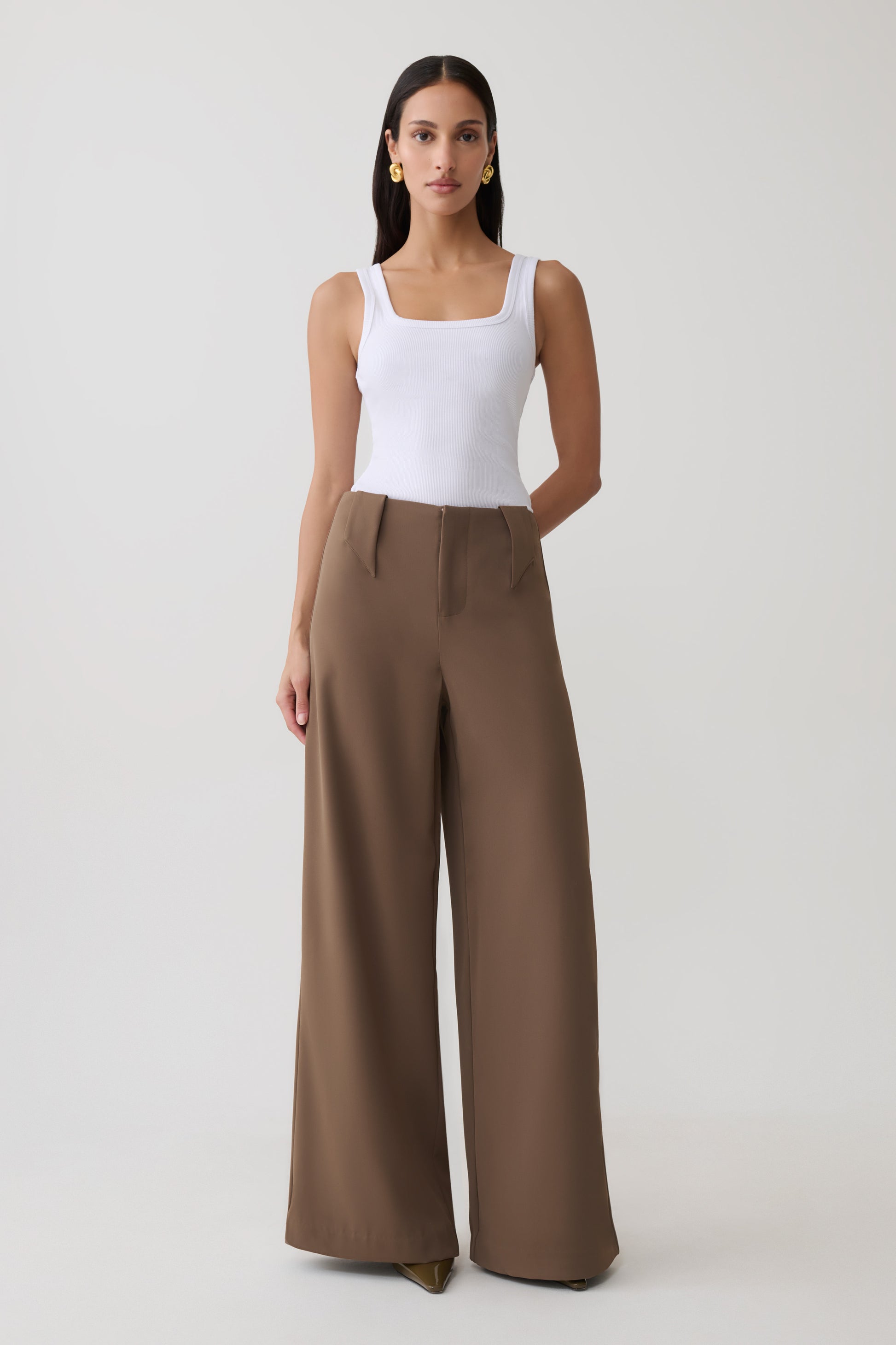 Woman wearing white tank with brown  wide leg suiting trouser.