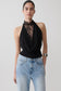 Woman wearing a black chiffon & lace halter top.