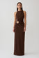 Woman wearing a brown maxi dress with silver hardware.