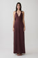 Woman wearing a brown draped shoulders satin maxi dress.