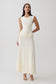Woman wearing white pleated midi dress.