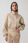 Woman wearing a gold satin bomber jacket.