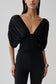 Woman wearing a black gathered bodice top.