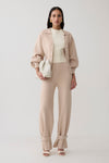 Woman wearing beige knit cuffed wide leg pants.