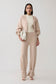 Woman wearing beige knit cuffed wide leg pants.