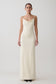 Woman wearing a white cowl maxi dress.