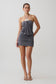 Woman wearing a grey halter with hardware mini dress.
