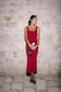 Woman wearing a red crepe midi dress.