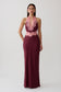 Woman wearing a burgundy satin and lace maxi dress.