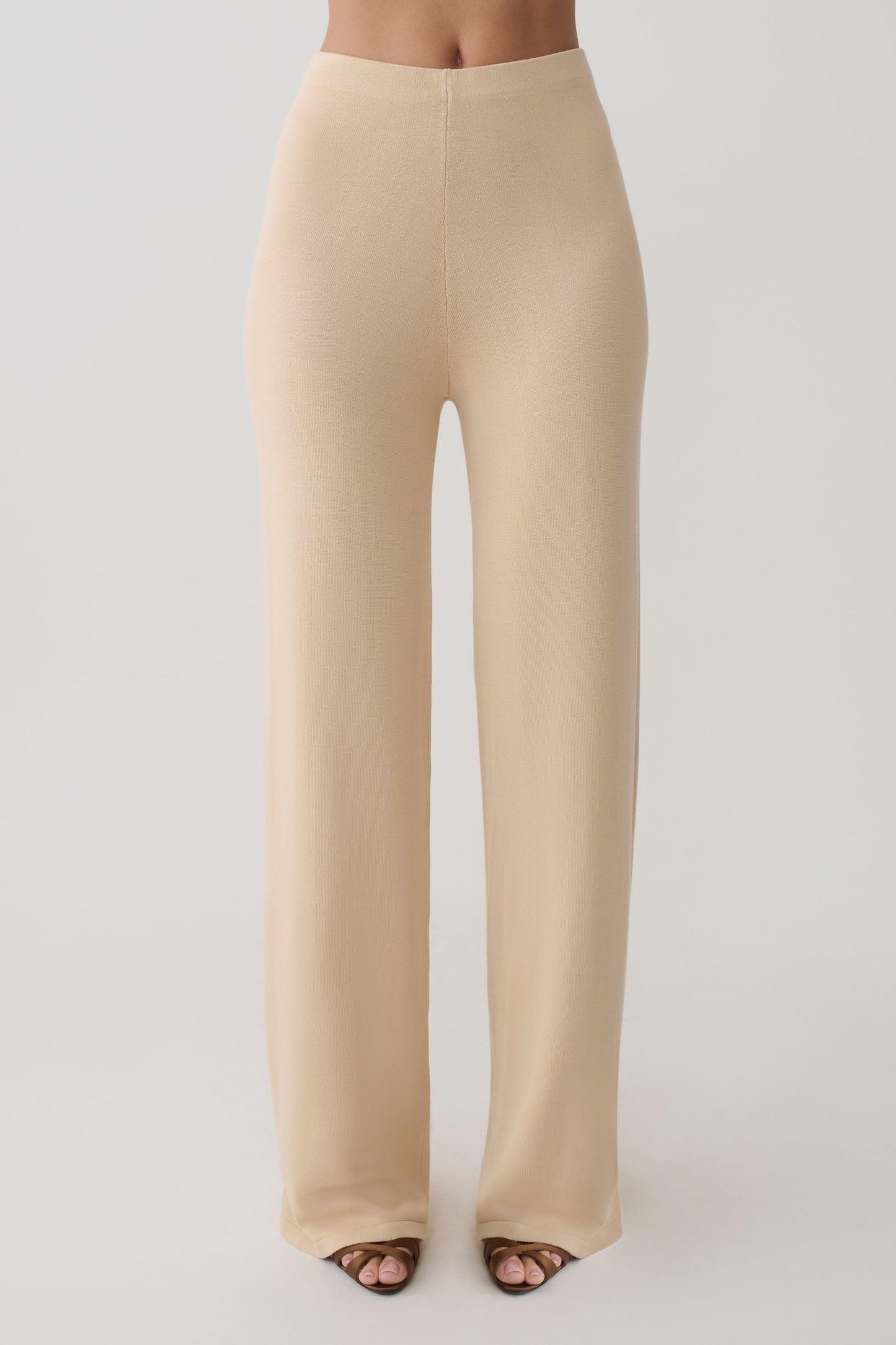 Woman wearing beige knit pants.