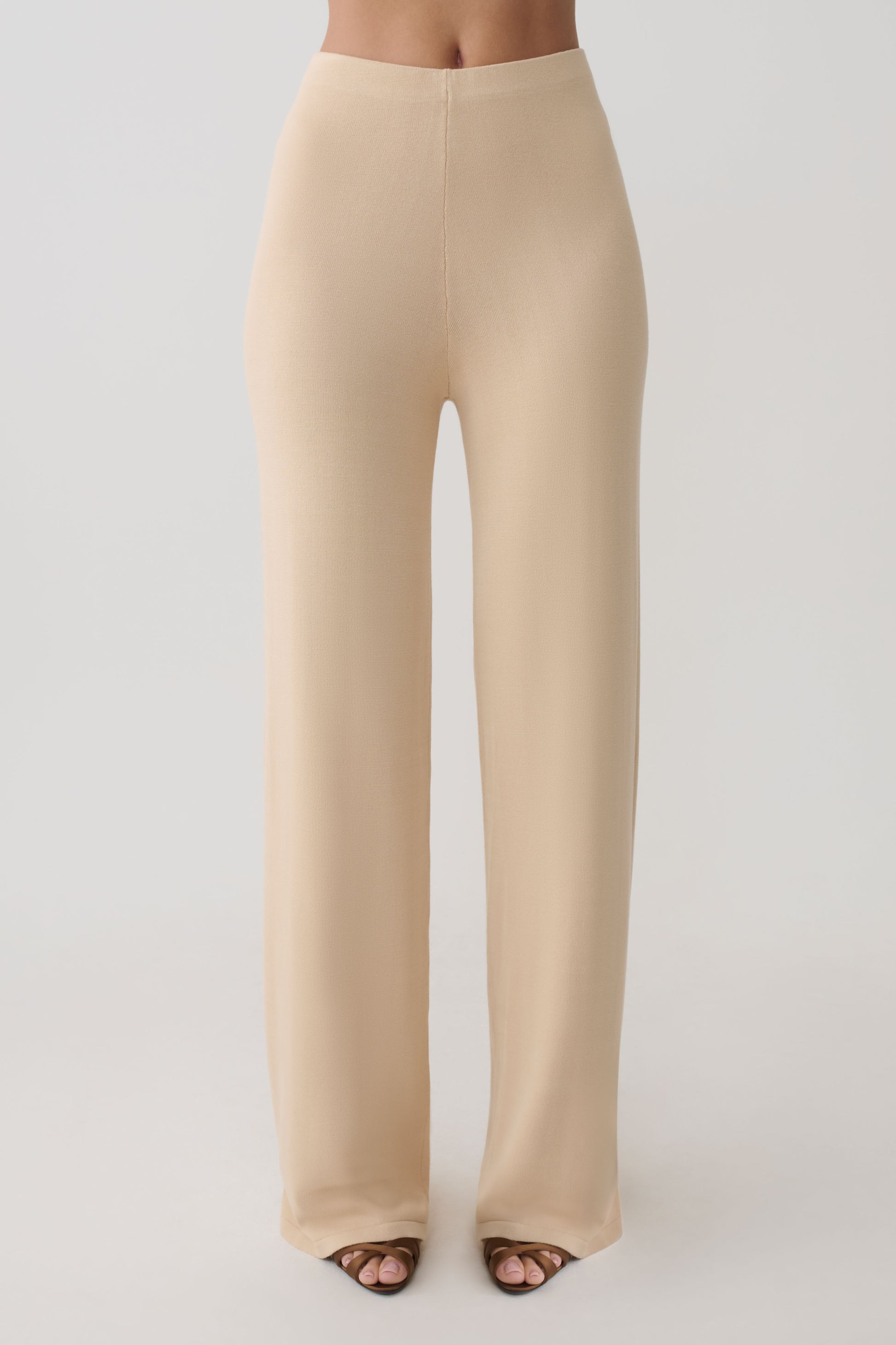 Woman wearing beige knit pants.