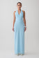 Woman wearing a light blue halter neck maxi dress.