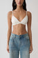 Woman wearing white micro triangle bralette.