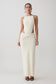 Woman wearing white sleeveless maxi dress.