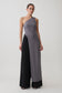 Woman wearing a grey long line top with front cut out.