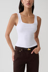 Woman wearing white square neck tank.