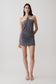 Woman wearing a grey halter with hardware mini dress.