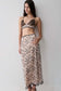 Woman wearing a a nude lace pencil midi skirt.