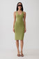 A woman modeling a sleeveless olive green bodycon midi dress with a scoop neckline, paired with dark sunglasses and brown strappy heels, against a plain light gray studio background.