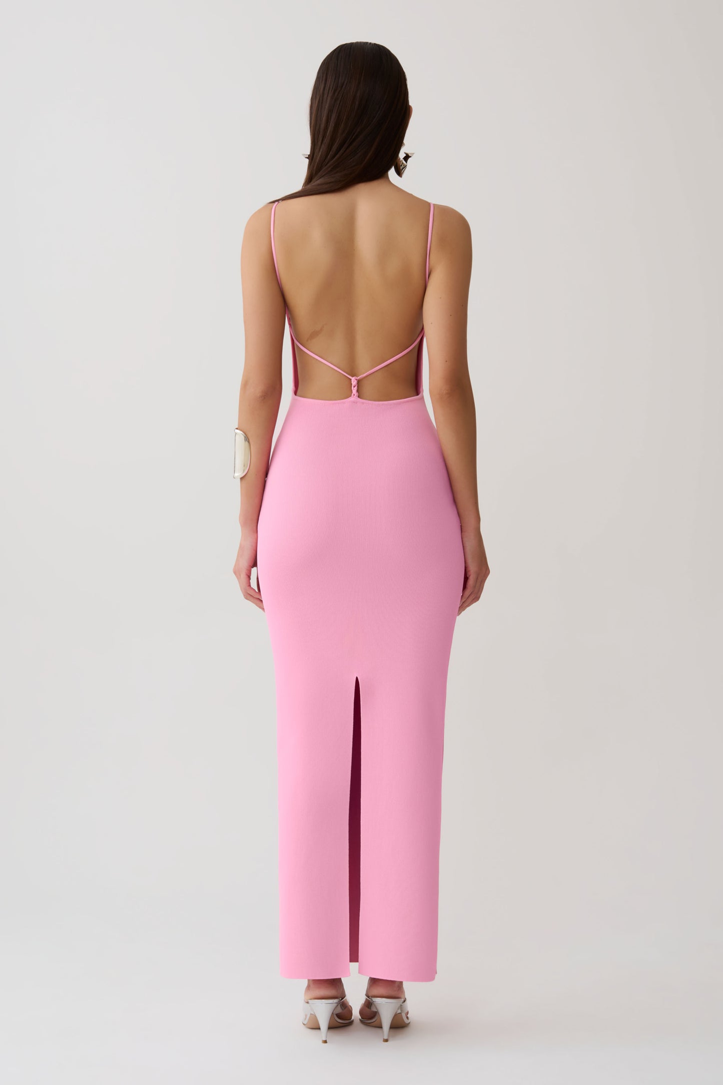 Woman wearing a strappy back bandage maxi dress.