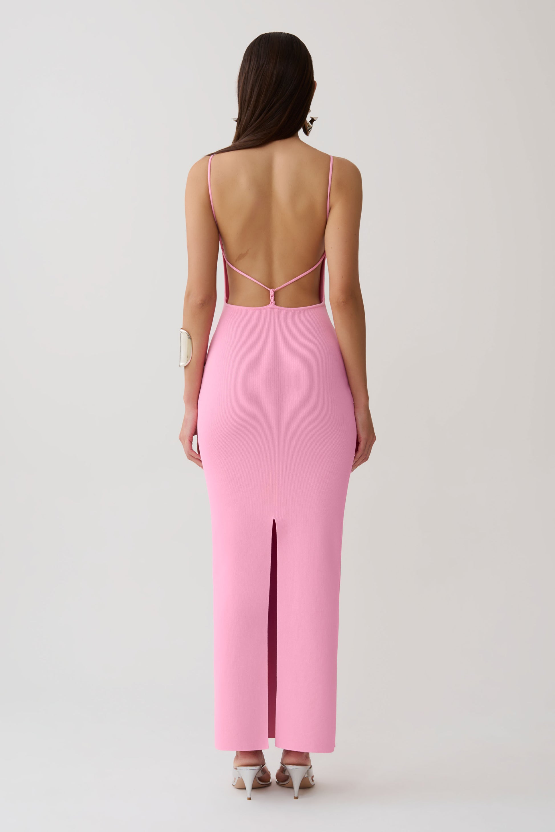 Woman wearing a strappy back bandage maxi dress.