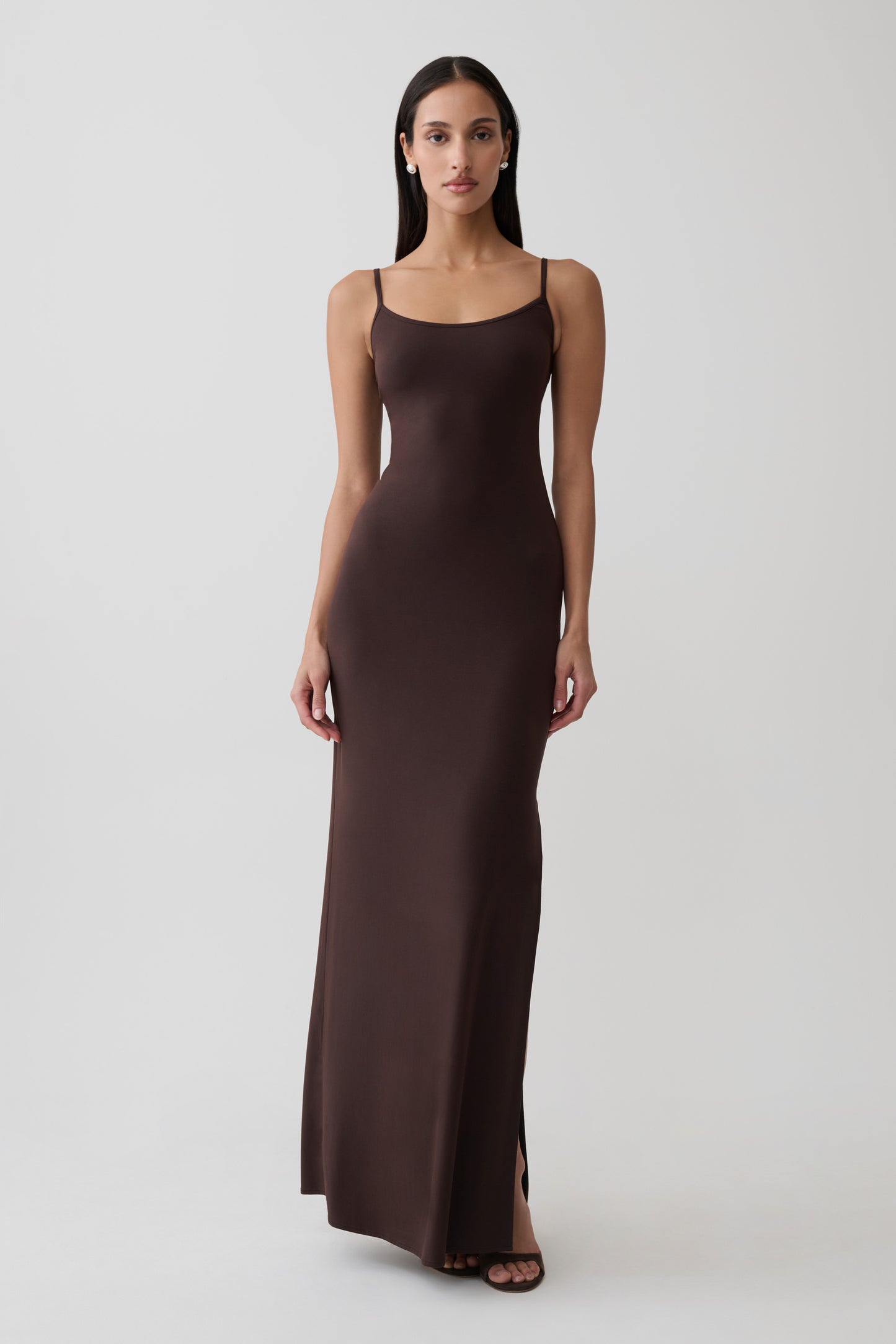 Woman wearing brown peached jersey maxi dress.