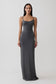 Woman wearing a grey peached jersey maxi dress.