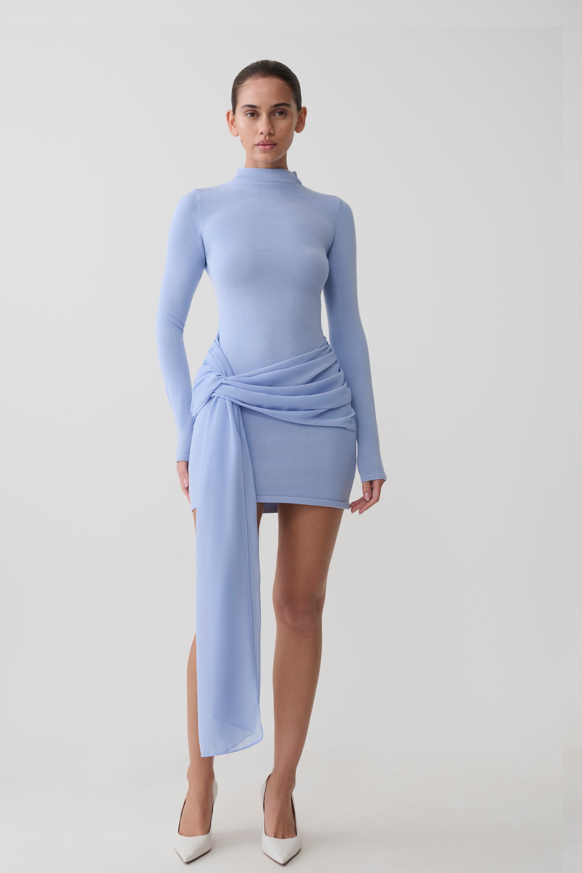Woman wearing a blue knit chiffon mini dress.