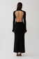 Woman wearing a black long sleeve knit maxi dress.