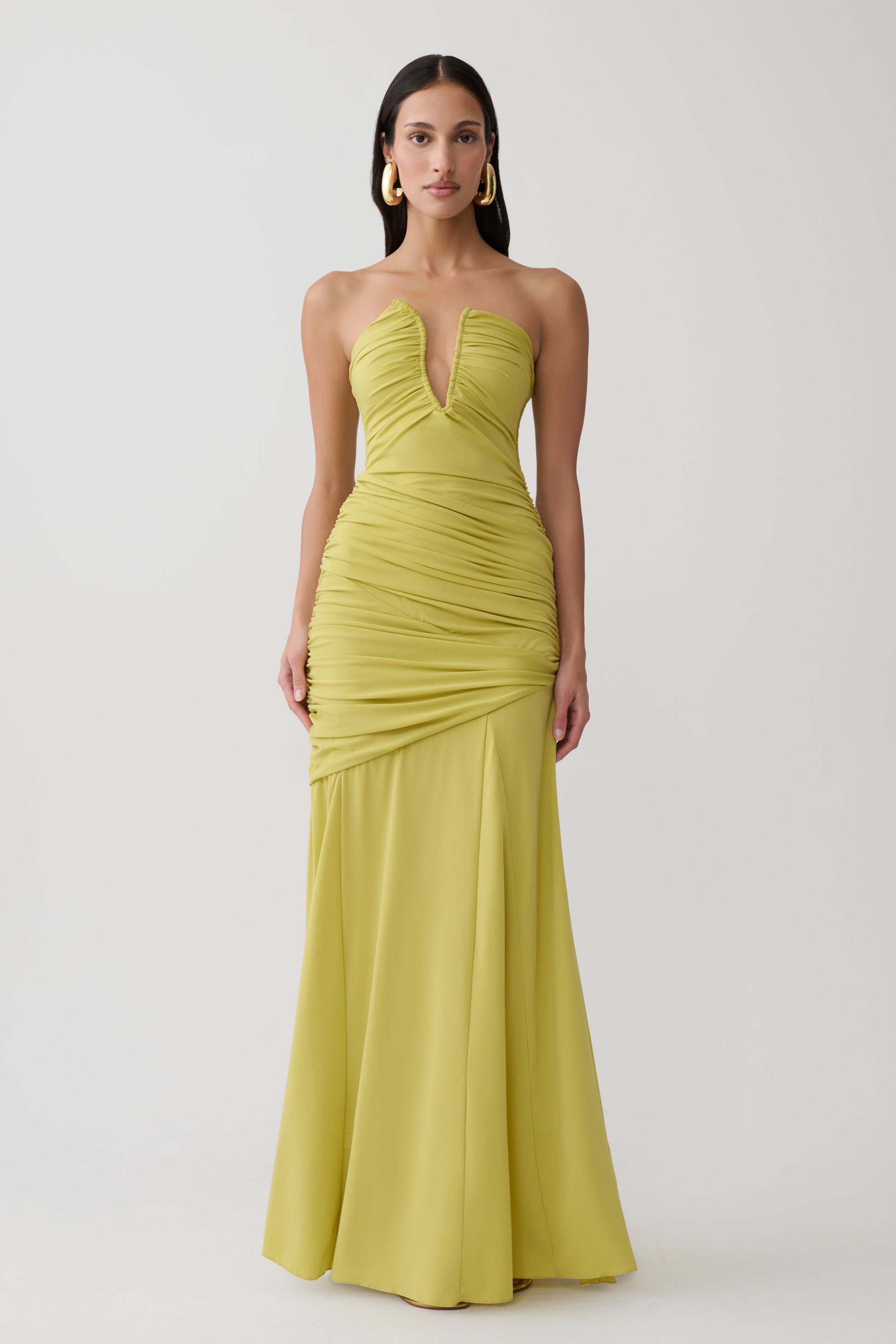 Woman wearing green gathered centre wire maxi dress.