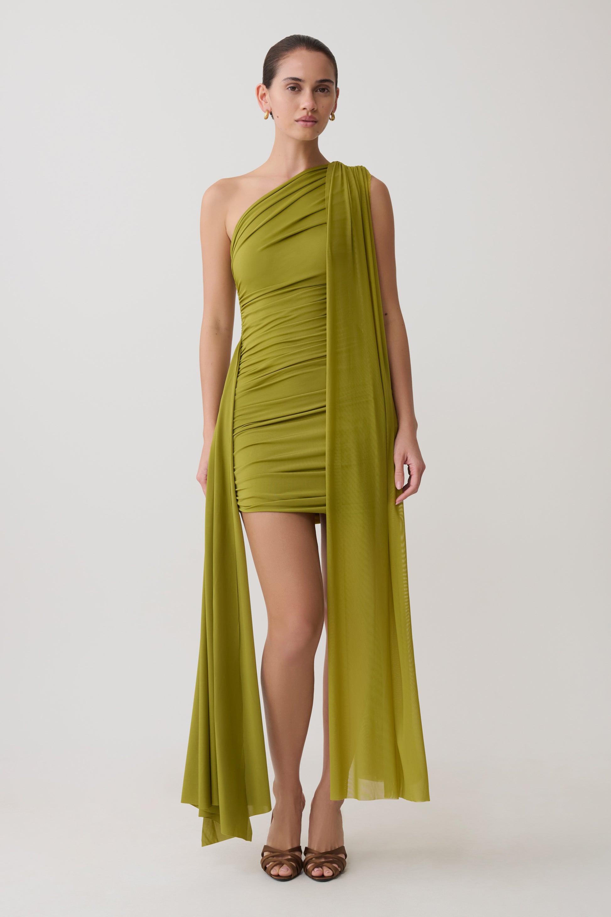 Woman wearing a green mini dress.