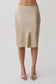 Woman wearing a gold satin midi skirt.