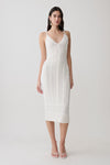 Woman wearing a white scalloped neckline pointelle midi dress.