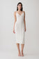 Woman wearing a white scalloped neckline pointelle midi dress.