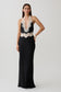 Woman wearing a black and white satin and lace maxi dress.